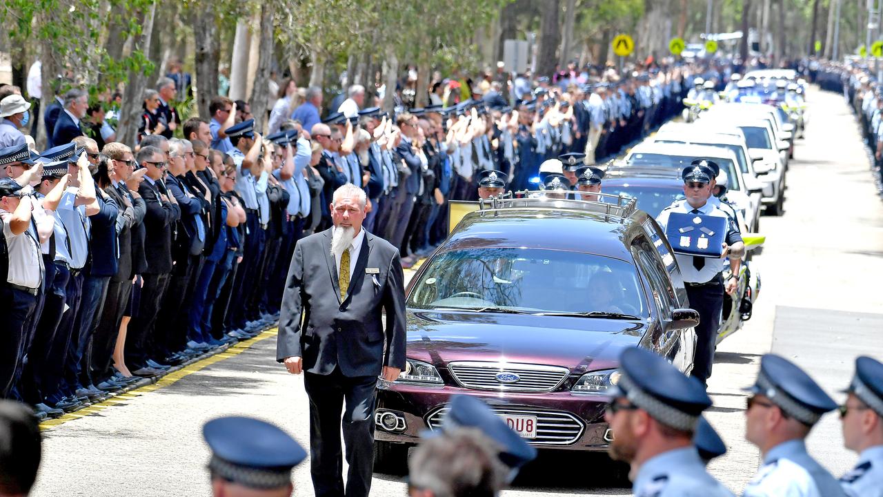 Police officers salute fallen constables Rachel McCrow and Matthew Arnold at the Brisbane Entertainment Centre. Picture: NCA NewsWire / John Gass