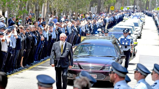 Police officers salute fallen constables Rachel McCrow and Matthew Arnold at the Brisbane Entertainment Centre. Picture: NCA NewsWire / John Gass