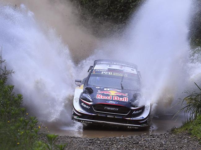 TOPSHOT - Ford driver Sebastien Ogier of France speeds through a creek on the first day of the World Rally Championship (WRC) Rally Australia near Coffs Harbour on November 16, 2018. (Photo by William WEST / AFP) / -- IMAGE RESTRICTED TO EDITORIAL USE - STRICTLY NO COMMERCIAL USE --