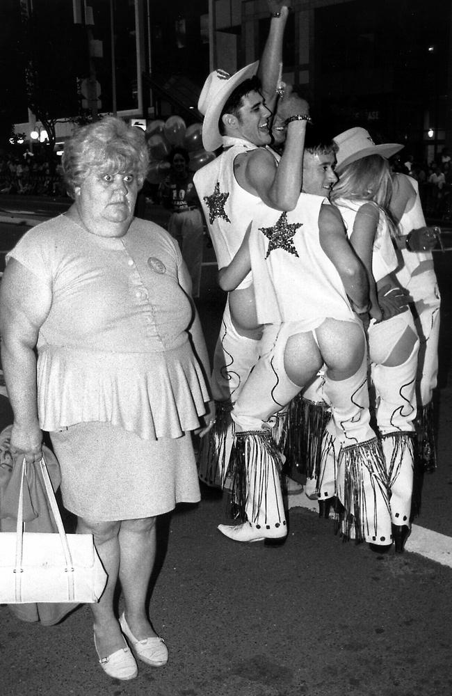 A startled spectator walks by at Sydney’s 1994 Mardi Gras parade. Picture: Mervyn Fitzhenry