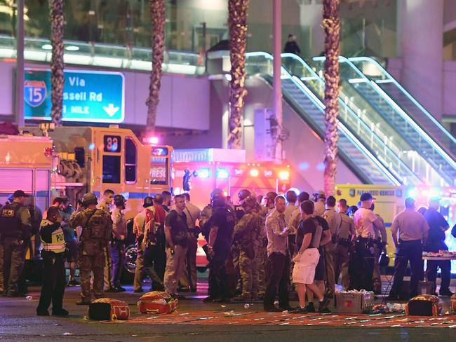 A body appears to lie under a sheet as police and rescue personnel gather at the intersection of Las Vegas Boulevard and Tropicana Ave after a shooting at a country music festival. Picture: Ethan Miller/Getty Images/