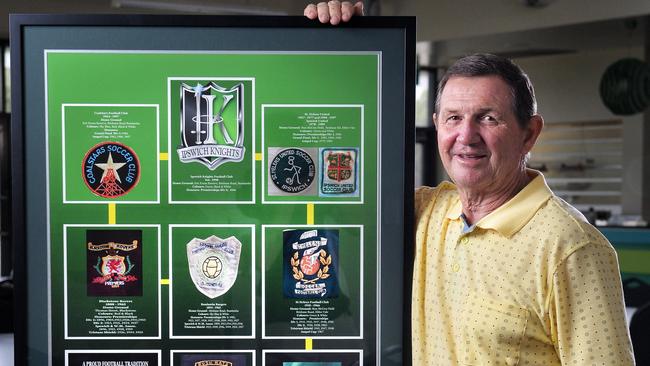 Ipswich Knights life member Ross Hallett with a special emblem memorabilia board commemorating the history of the soccer club.