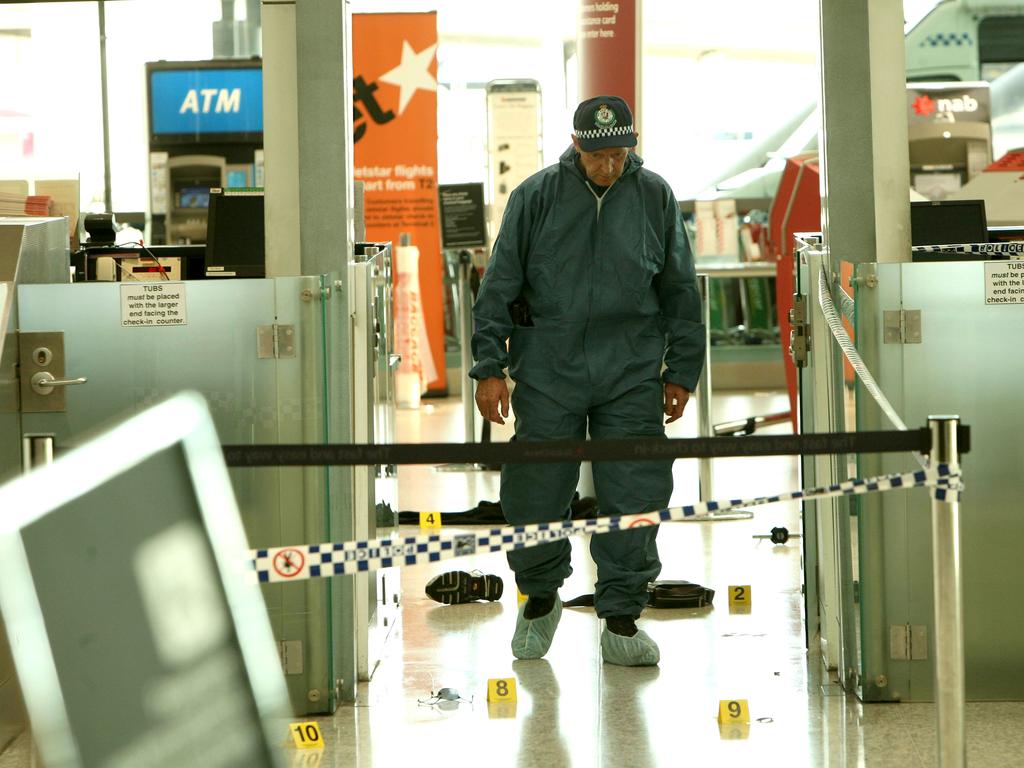 A forensic officer at the scene of a murder iat Sydney Airport.