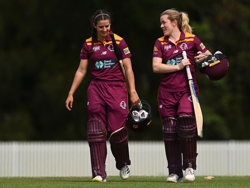 GOLD COAST, AUSTRALIA - OCTOBER 03: Charli Knott and Georgia Redmayne of Queensland leave the field after scoring the match winning runs during the WNCL match between Queensland and the Australian Capital Territory at Bill Pippen Oval, on October 03, 2022, in Gold Coast, Australia. (Photo by Albert Perez/Getty Images)