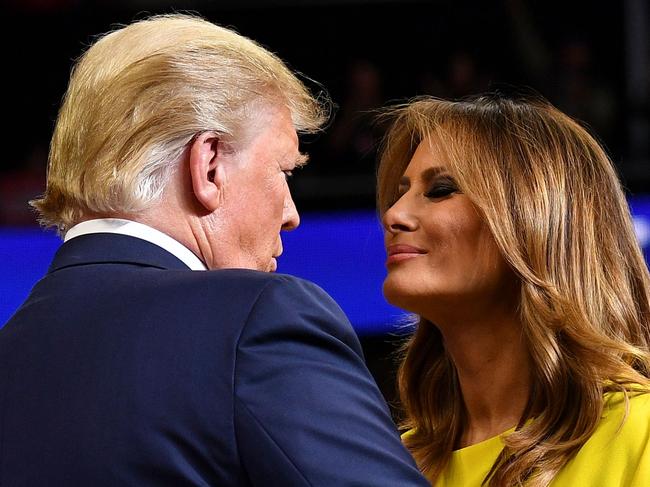 TOPSHOT - US President Donald Trump greets First Lady Melania Trump as he takes the stage for the official launch of the Trump 2020 campaign at the Amway Center in Orlando, Florida on June 18, 2019. - Trump kicks off his reelection campaign at what promised to be a rollicking evening rally in Orlando. (Photo by MANDEL NGAN / AFP)