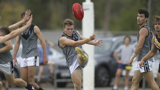 Jack Strange gets a clearing kick away for Uni earlier this season. Picture: AAP/Dean Martin