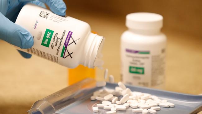 A pharmacy tech pours out pills of Hydroxychloroquine at Rock Canyon Pharmacy in Provo, Utah, on May 20, 2020. - US President Donald Trump announced May 18 he has been taking hydroxychloroquine for almost two weeks as a preventative measure against COVID-19. (Photo by GEORGE FREY / AFP)