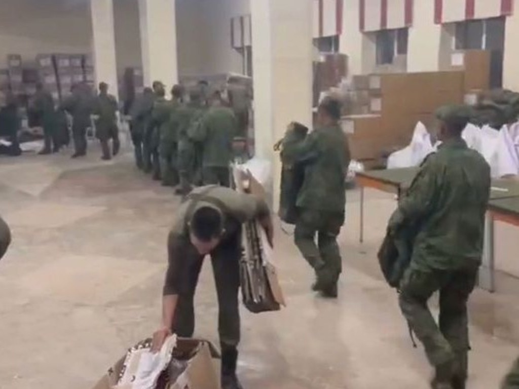 Still from video imagery of North Korean soldiers receiving uniforms and equipment at a Russian training base.