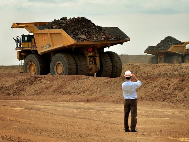 (FILES) This file photo taken on June 23, 2012 shows trucks working the open pit mine at the Rio Tinto operated Oyu Tolgoi gold and copper mine in the Gobi desert, southern Mongolia. Rio Tinto on February 8, 2017 reported a surge in annual net profit on the back of improving commodity prices in a strong turnaround from last year's loss, and rewarded shareholders with a buyback.  / AFP PHOTO / MARK RALSTON