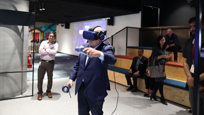 Tim Pallas plays Roger Federer in virtual reality.