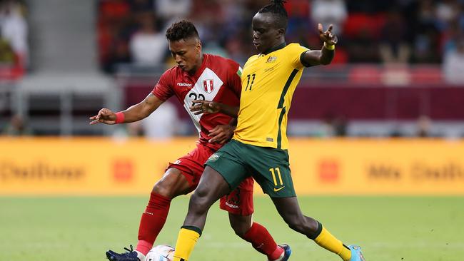 Pedro Aquino of Peru battles for possession with Awer Mabil of Australia during the 2022 FIFA World Cup Playoff match. Picture: Mohamed Farag/Getty Images