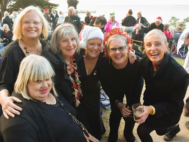 Irene Bennetts, Maria Kirwan, Bev Watson, Susan Hulme, Helen Murray and Mary Taylor getting festive at the Phillip Island Christmas Carols by the Bay at the Cowes Foreshore on Tuesday, December 10, 2024. Picture: Jack Colantuono