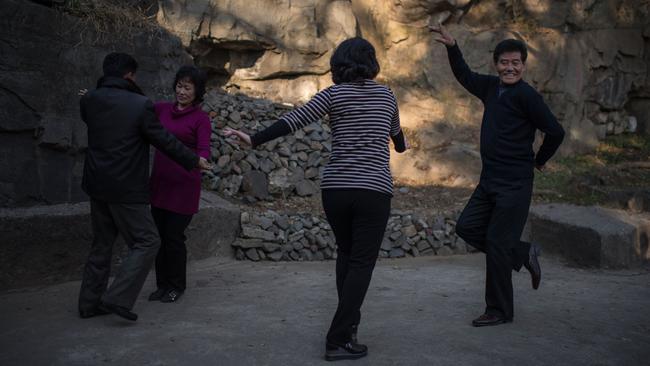 People dance in a park in Pyongyang, North Korea. Picture: AFP / Ed Jones.