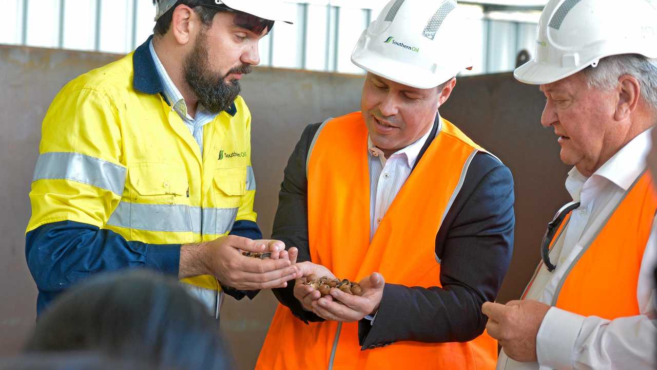 Northern Oil's Yarwun Advanced BioFuels Pilot Plant general manager Ben Tabulo with Minister for the Environment and Energy Josh Frydenberg and member for Flynn Ken O'Dowd with macadamia shells. Picture: Mike Richards GLA260718NOIL
