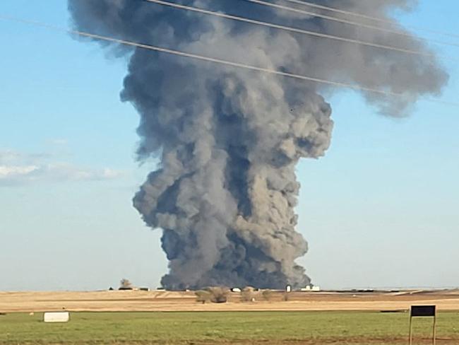 This image obtained from the Facebook page of Castro County Sheriff's Office shows a plume of smoke rising from the Southfork Dairy Farms, after an explosion and a fire killed around 18,000 cows, near Dimmitt, Texas, on April 11, 2023. - A "horrific" explosion and fire at a dairy farm in the southern US state of Texas killed about 18,000 head of cattle and injured one agricultural worker, authorities said on Thursday April 13, 2023. (Photo by Castro County Sheriff's Office / AFP) / RESTRICTED TO EDITORIAL USE - MANDATORY CREDIT "AFP PHOTO / Facebook page of Castro County Sheriff's Office " - NO MARKETING - NO ADVERTISING CAMPAIGNS - DISTRIBUTED AS A SERVICE TO CLIENTS