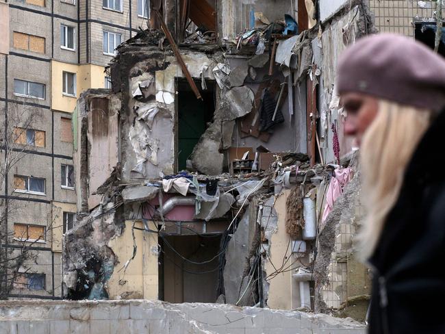 A woman walks past a residential building in Dnipro after one of the deadliest attacks since Russia invaded Ukraine nearly 11 months ago. Picture: AFP