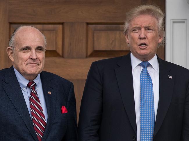 Former New York City mayor Rudy Giuliani stands with president-elect Donald Trump. Picture: Getty