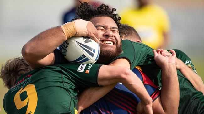 Campbelltown’s Xavier Saukuru wrapped up by Lions players David Eccleston and Matthew Parkes.