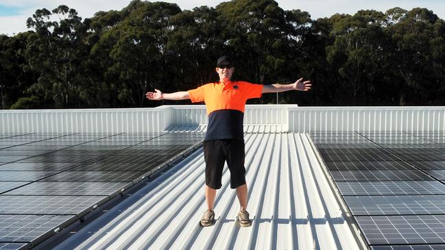 Chris Bulanyi takes in the atmosphere on the Rigby House after installing solar panels for Coffs Harbour City Council. Photo Bruce Thomas