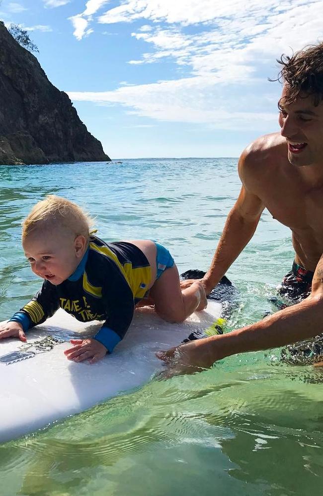 Johnson teaching his nephew George to surf on Stradbroke Island Picture: Instagram