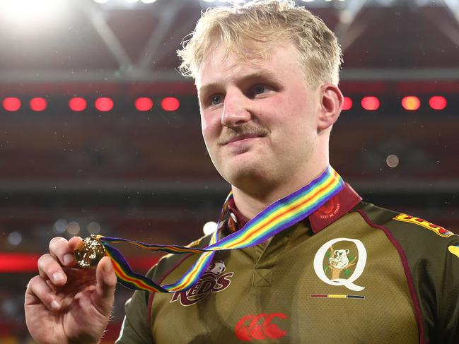 BRISBANE, AUSTRALIA - APRIL 25:  Tom Lynagh of the Reds hold the ANZAC medal after the round 11 Super Rugby Pacific match between Queensland Reds and Blues at Suncorp Stadium, on April 25, 2025, in Brisbane, Australia. (Photo by Chris Hyde/Getty Images)