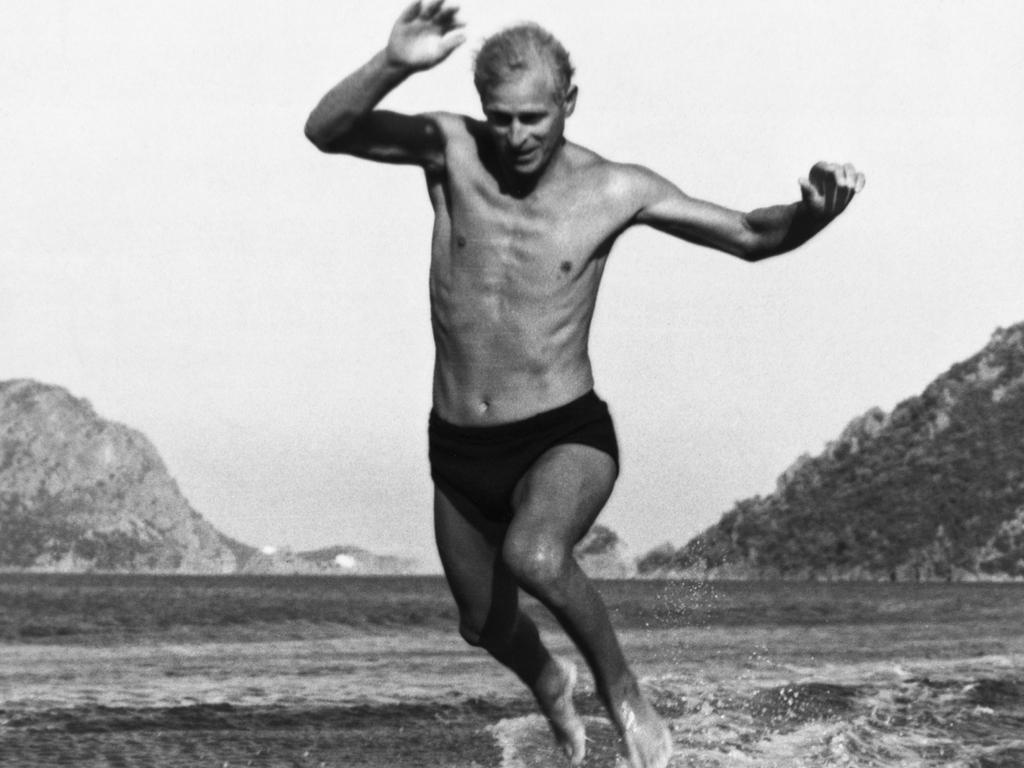 These photographs were taken during the Mediterranean Fleet's summer cruise. The Duke of Edinburgh jumping off the water skis as he reaches the beach in Turkey, taken by a private photographer by permission of the Duke of Edinburgh. Picture: Hulton-Deutsch Collection/CORBIS/Corbis via Getty Images