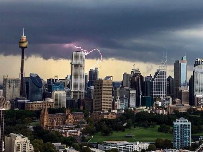 Lightning strikes the Sydney skyline at 4.04pm. Picture: Kyle Loughlin