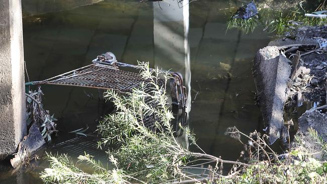 A dumped shopping trolley under Railway Parade bridge at Canley Vale. Picture: Carmela Roche