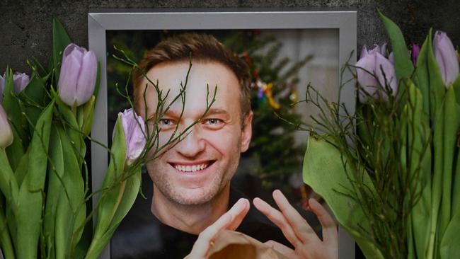 Flowers are seen placed around portraits of late Russian opposition leader Alexei Navalny, who died in a Russian Arctic prison. Picture: AFP