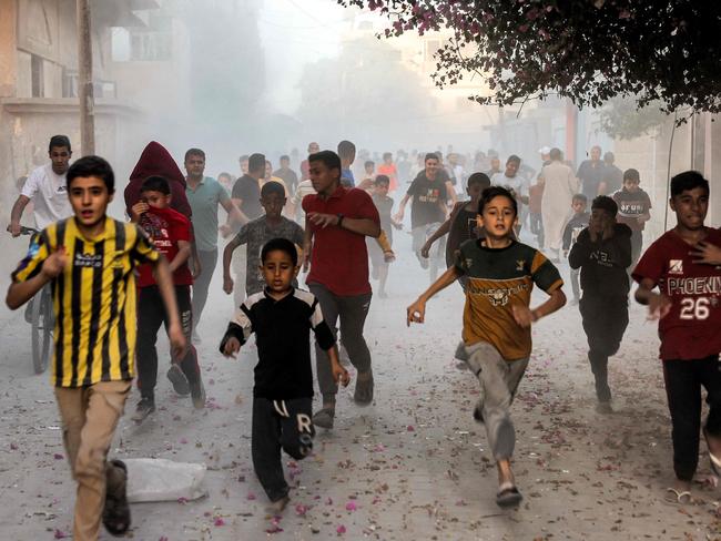 Palestinian children run as they flee from Israeli bombardment in Rafah in the southern Gaza Strip. Picture: AFP