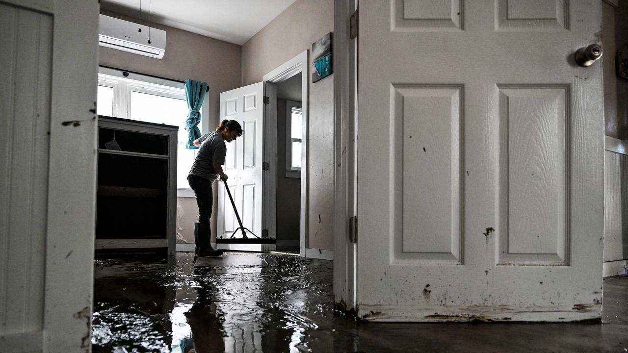 Deanna Fernandez cleans her house after Hurricane Helene made landfall in Cedar Key, Florida. Picture: Chandan Khanna/AFP