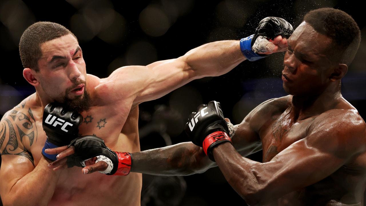 Robert Whittaker lands a punch on Israel Adesanya at UFC 271 in February. Picture: Carmen Mandato/Getty Images