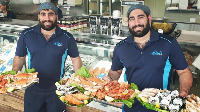 Costa's Seafood Cafe owners Chris and Jason Tapinos with their seafood platters.