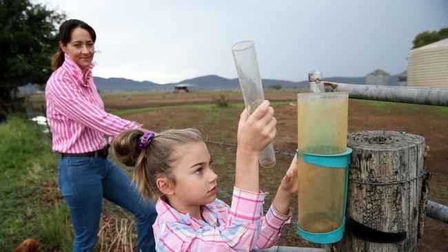 Central Queenslander’s shouldn’t expect much in their rain gauges according to the Bureau of Meteorology, with significant rain expected further south. Felicity Mammen, 7, checks the rain gauge with mum Janice Mammen on the family's farm.