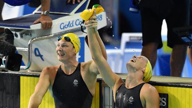 Bronte Campbell celebrates, as Cate Campbell of Australia looks on, after winning the women’s 100m freestyle final.