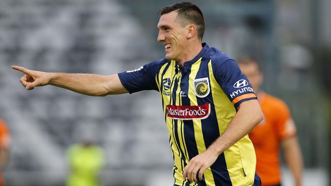 Matt Millar celebrates after scoring against the Brisbane Roar this season. (AAP Image/Darren Pateman) 