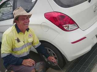 In a random act of kindness Reg Gilroy helped The Gympie Times photographer fish her car keys out of the drain. 