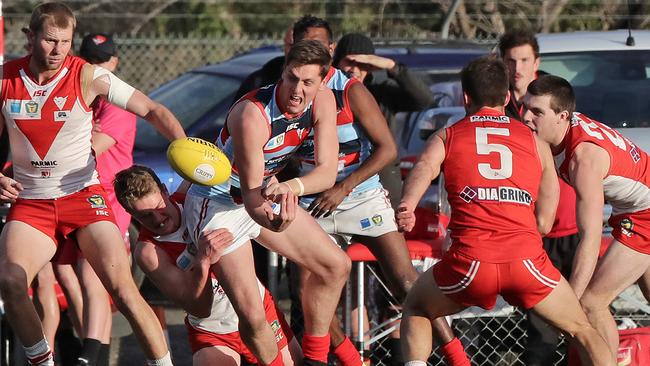 Josh McGuinness offloads the ball under pressure against Clarence last year. Picture: LUKE BOWDEN