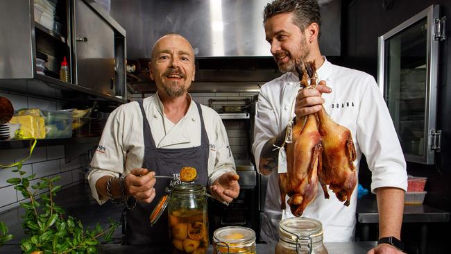 Jock Zonfrillo (R) with chefs Simon Bryant at Orana Restaurant in Adelaide.