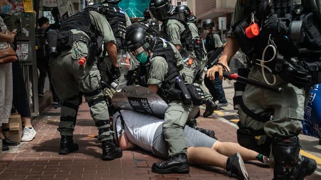 A man is detained by riot police during a demonstration in Hong Kong last night. Picture: Getty Images