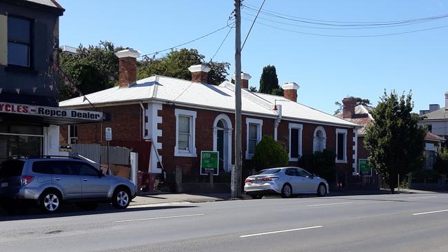 Police blocking the footpath on Wellington St, Launceston, following the suspicious death of Jingai Zhang.