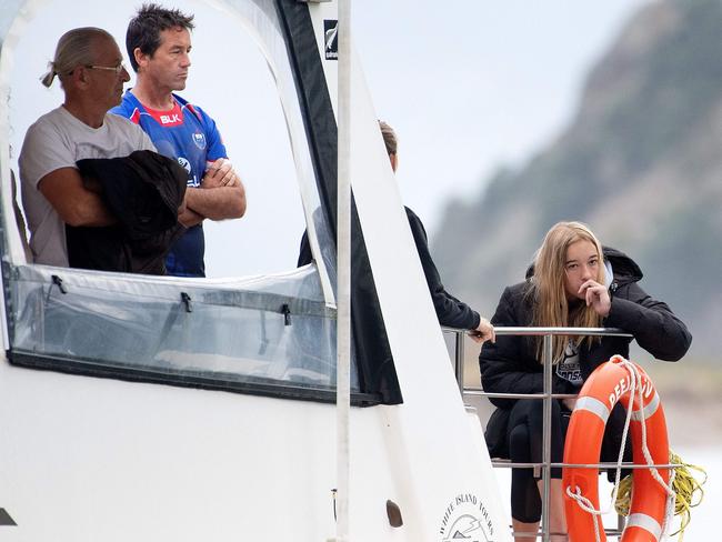 Mark Inman (top left in blue), brother of Hayden Marshall-Inman, arrives on a White Island Tours boat after a blessing at sea in Whakatane, New Zealand. Picture: AFP