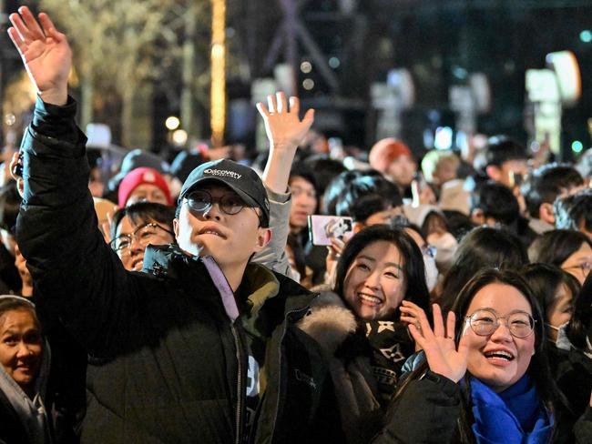 People gesture during 2025 New Year's Day celebrations, post midnight at the Bosingak pavilion in central Seoul on January 1, 2025. Picture: AFP