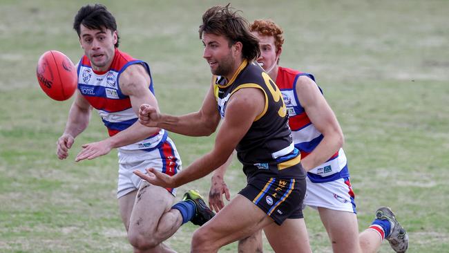 WRFL: Rylan Williams fires off a handball for Caroline Springs. Picture: George Sal