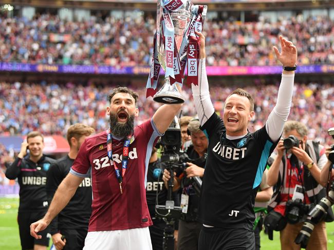 Mile Jedinak, left, lifts the Championship playoff trophy with John Terry.