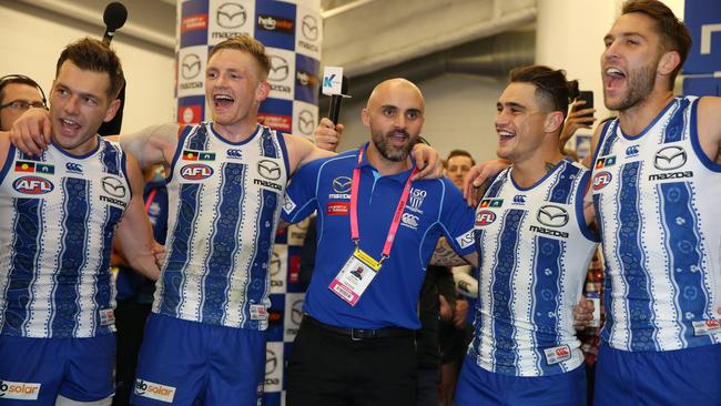 North Melbourne players join in the chorus with coach Rhyce Shaw. Picture: Michael Klein