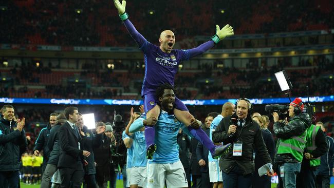 Manchester CIty's Argentinian goalkeeper Willy Caballero (top) celebrates.