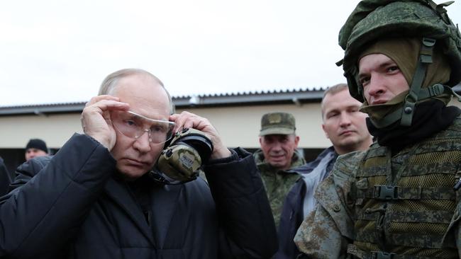 Vladimir Putin meets soldiers during a visit at a military training centre for mobilised reservists last week. Picture: AFP