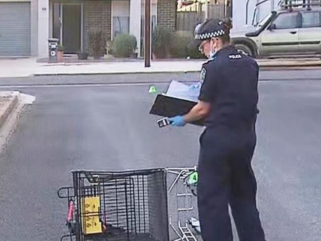 Police examine a shopping trolley as a 34-year-old man is clinging to life after a brutal assault at Murray Bridge. Picture: 7NEWS Adelaide