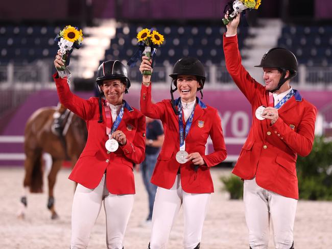 Laura Kraut, Jessica Springsteen and McLain Ward of Team United States pose with their silver medals.